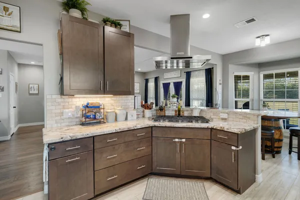 a kitchen with granite countertop a sink and cabinets