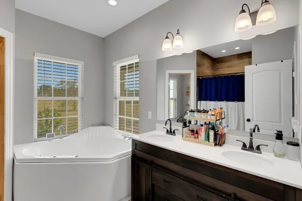 a bathroom with a sink double vanity and a tub