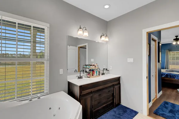 a bathroom with a sink double vanity and a mirror