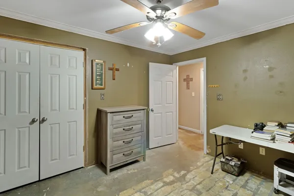 a view of room with cabinet mirror and fan