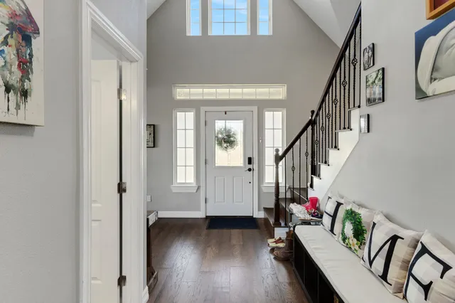 a view of entryway with wooden floor and stairs