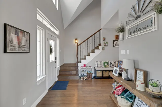 a living room with furniture and stairs