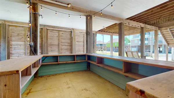 a dining hall with couches a dining table and chairs with wooden floor