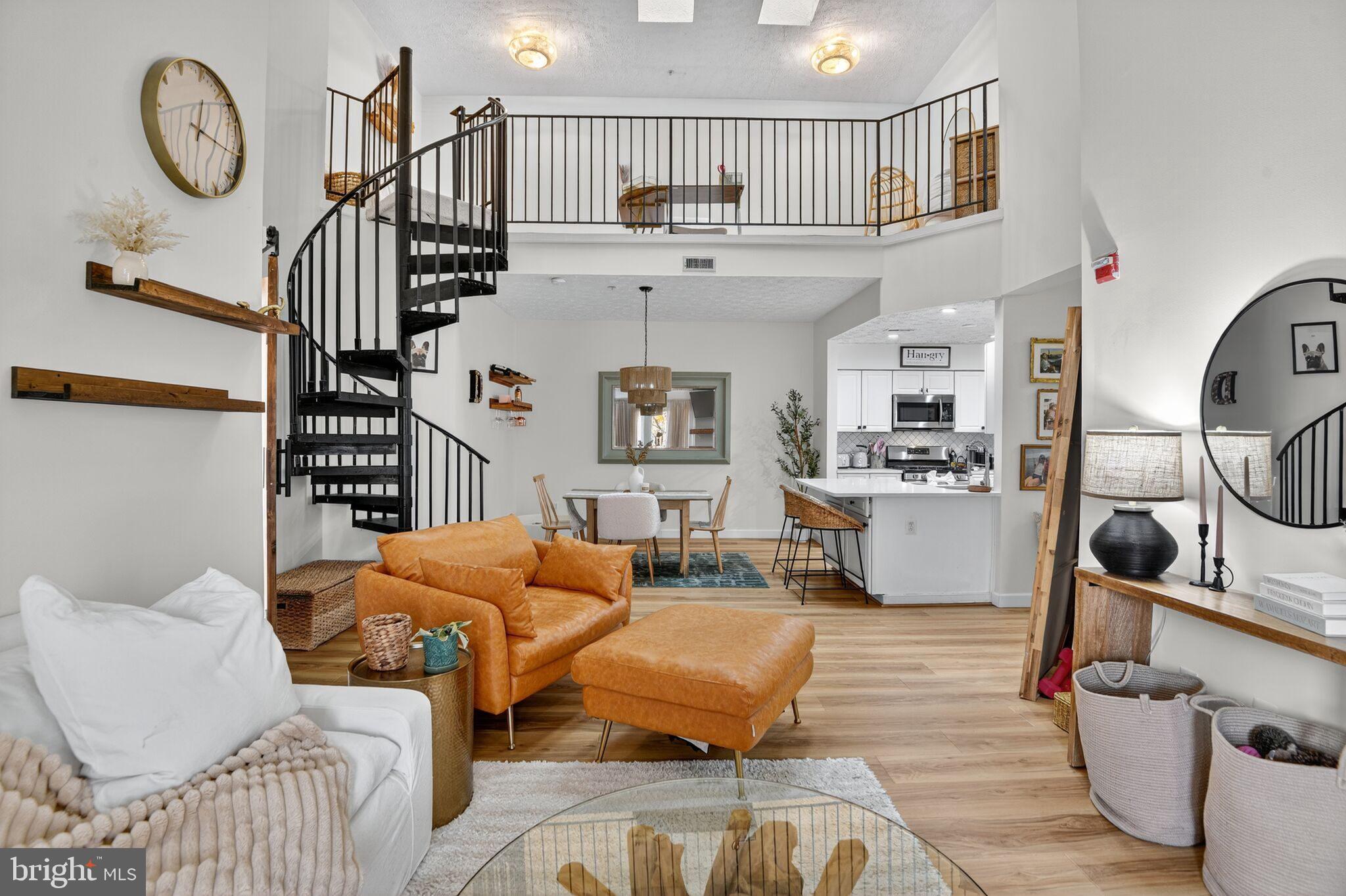 2013 Warners Terrace South, Unit 348 Annapolis, MD 21401 - Photo 1 of 23 a living room with furniture a wooden floor and a chandelier