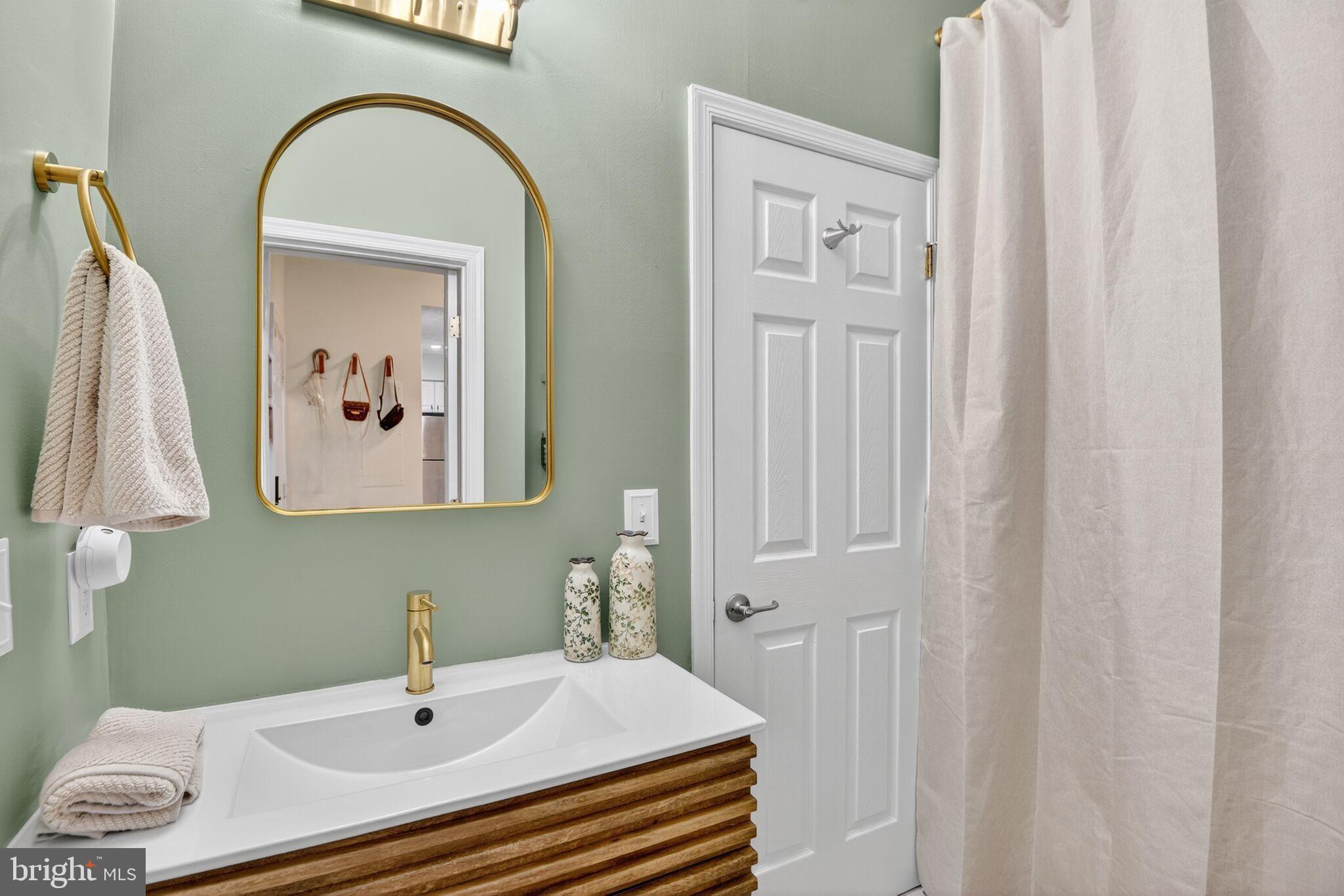 2013 Warners Terrace South, Unit 348 Annapolis, MD 21401 - Photo 13 of 23 a bathroom with a sink and a mirror