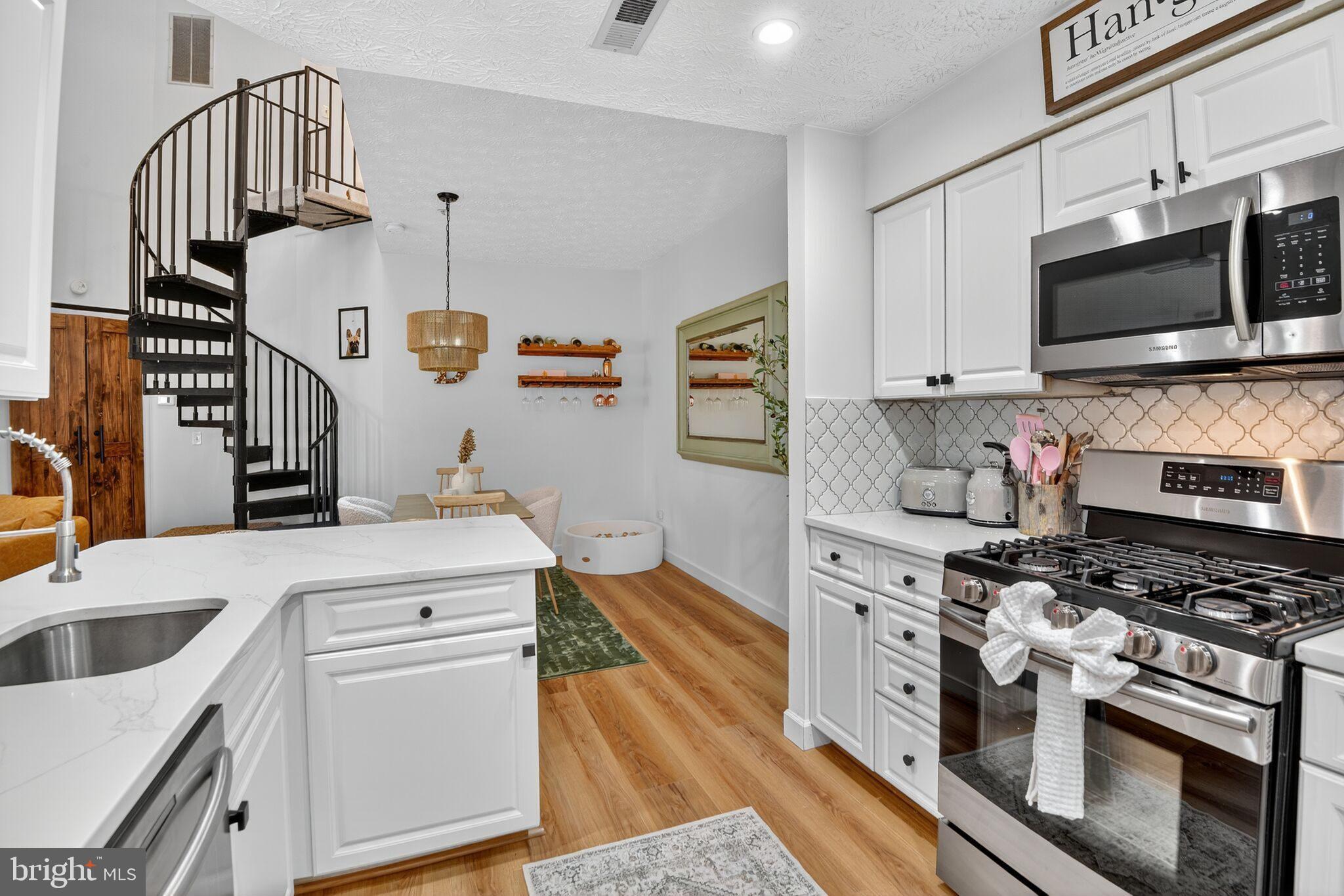 2013 Warners Terrace South, Unit 348 Annapolis, MD 21401 - Photo 6 of 23 a kitchen with stainless steel appliances granite countertop a stove and a sink