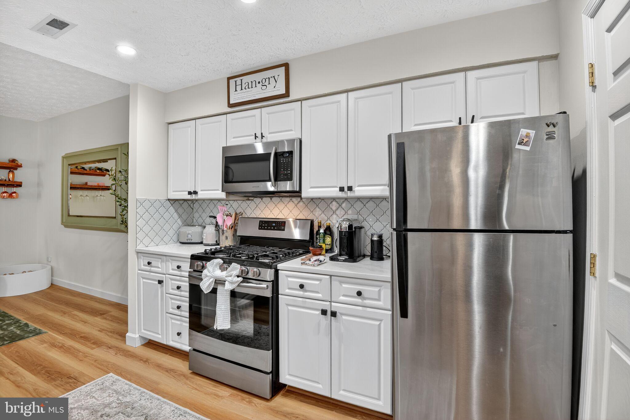 2013 Warners Terrace South, Unit 348 Annapolis, MD 21401 - Photo 7 of 23 a kitchen with stainless steel appliances a refrigerator stove and microwave