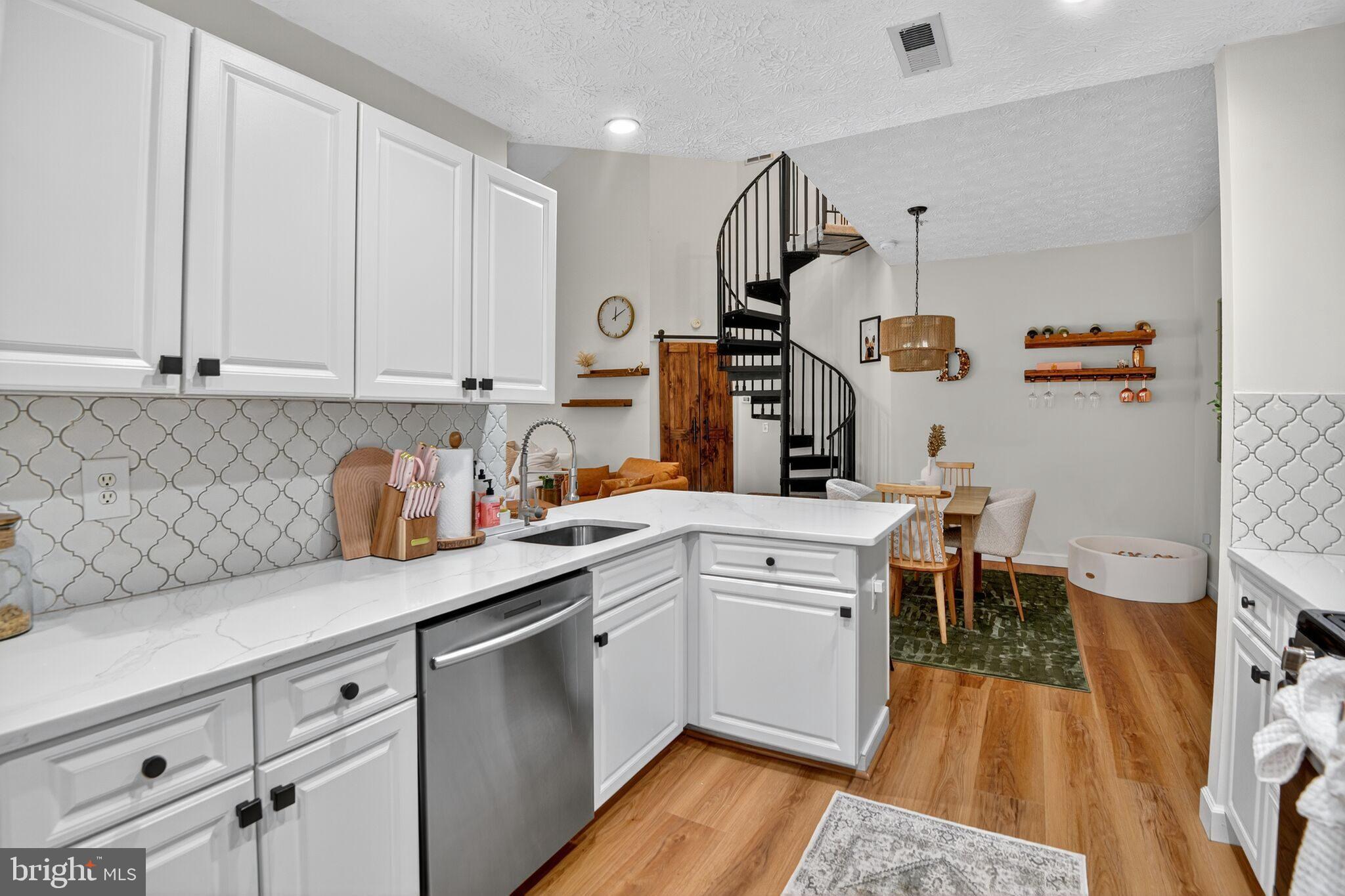 2013 Warners Terrace South, Unit 348 Annapolis, MD 21401 - Photo 8 of 23 a kitchen with granite countertop white cabinets and white appliances