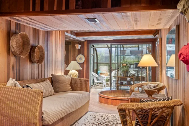 a living room with patio furniture and a large window