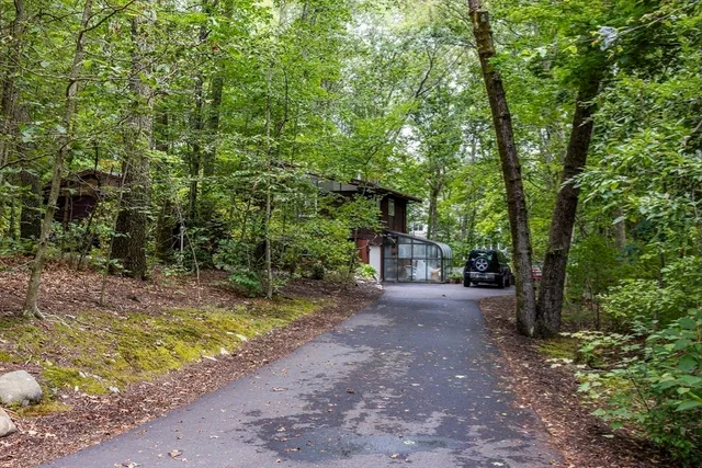 a view of a house with large trees
