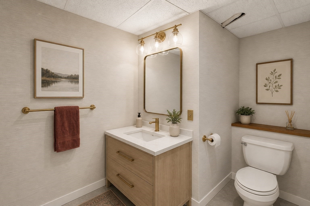 67 Wituwamat Road Weymouth, MA 02191 - Photo 36 of 42 a bathroom with a toilet sink and mirror