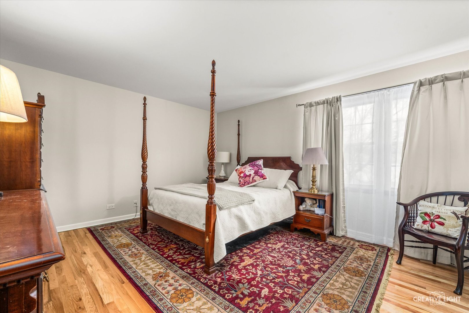 1712 Coach Drive Naperville, IL 60565 - Photo 14 of 39 a bedroom with a bed wooden floor and flat screen tv