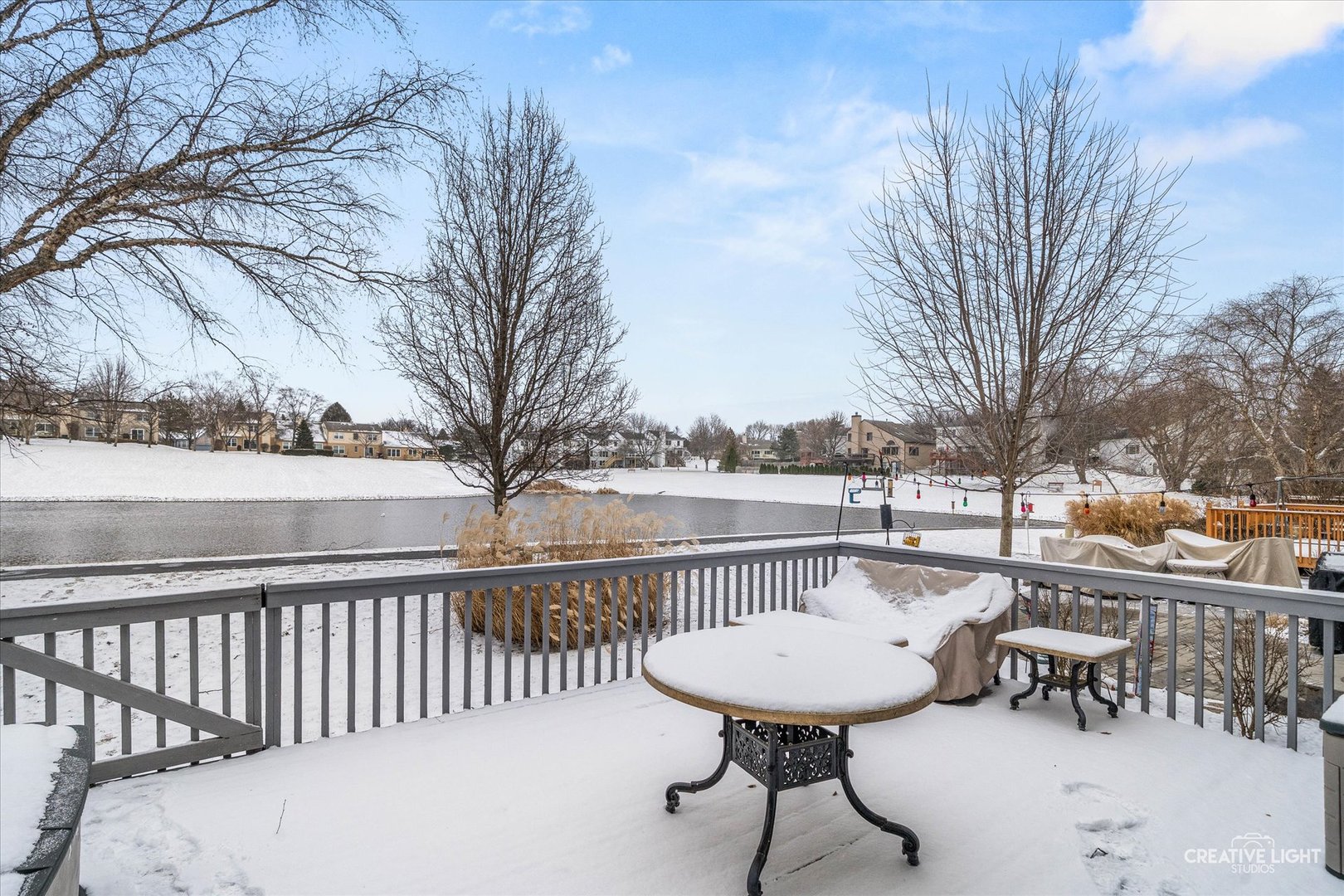 1712 Coach Drive Naperville, IL 60565 - Photo 22 of 39 a view of a chairs and table on the roof deck with wooden fence and floor