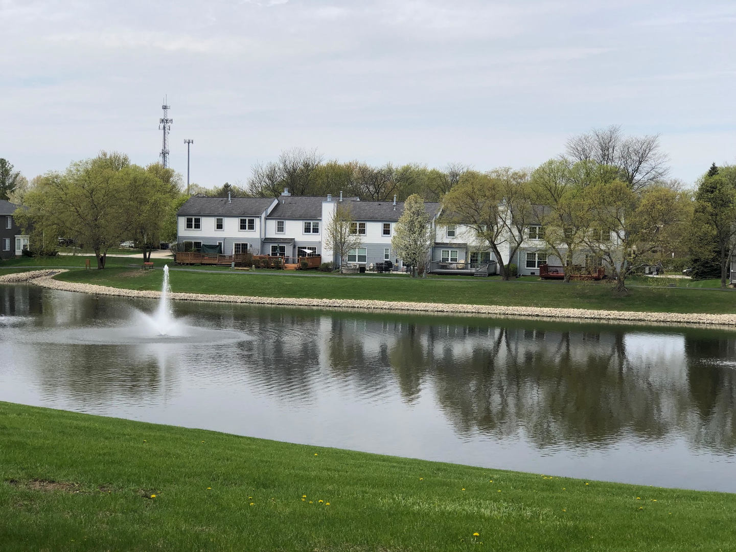 1712 Coach Drive Naperville, IL 60565 - Photo 24 of 39 a view of a lake with a house in the background