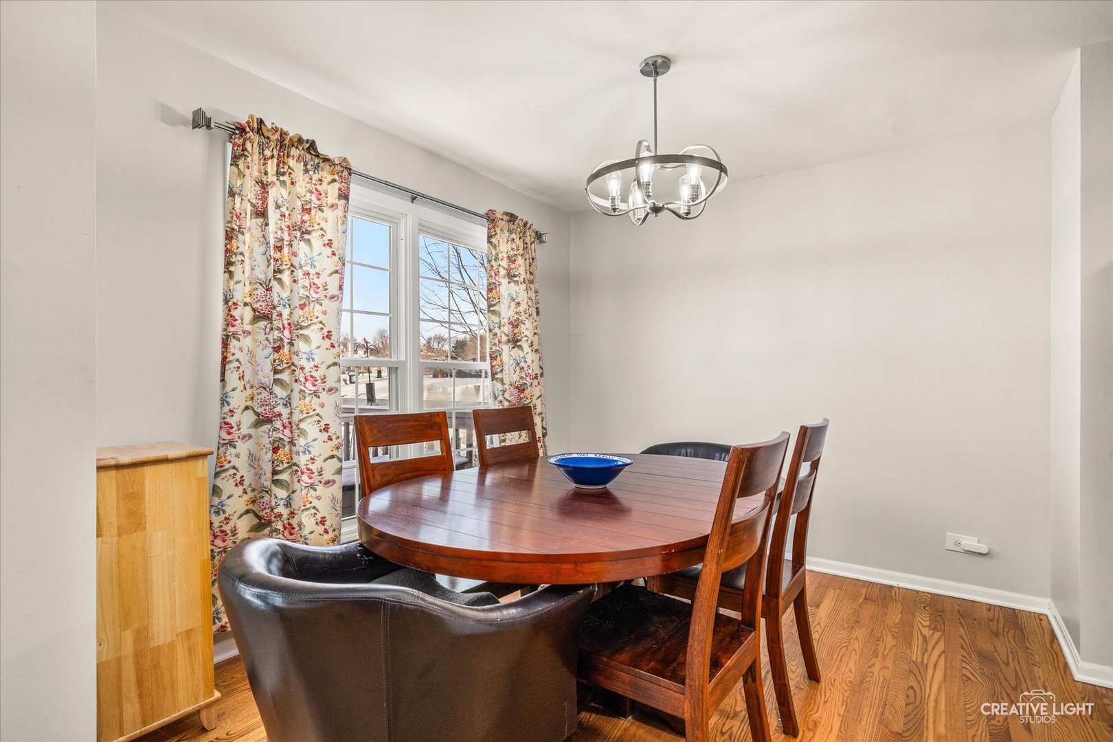 1712 Coach Drive Naperville, IL 60565 - Photo 6 of 39 a dining room with furniture wooden floor and a chandelier