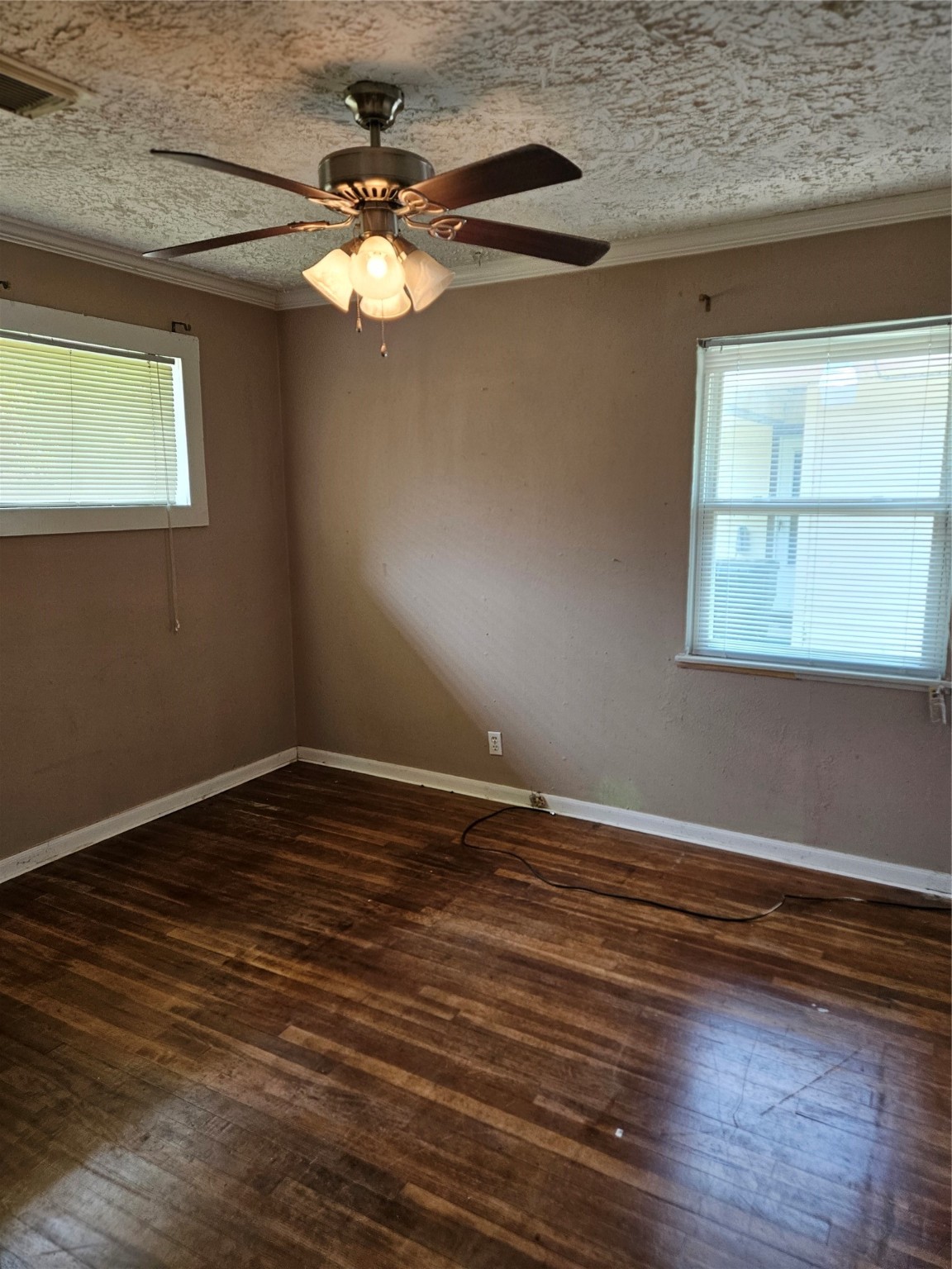5218 Cortelyou Lane Houston, TX 77021 - Photo 19 of 45 a view of an empty room with wooden floor and a window