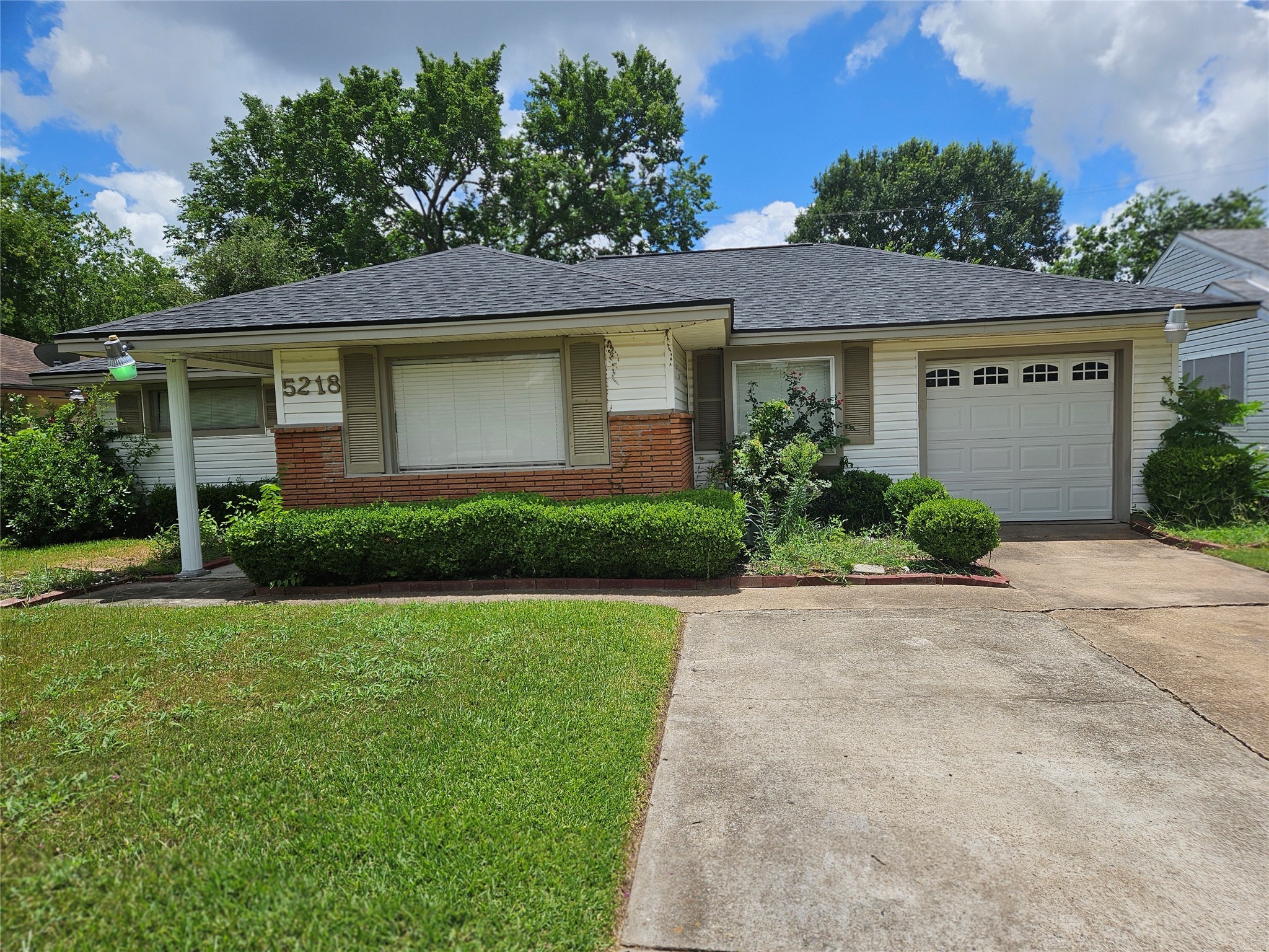 5218 Cortelyou Lane Houston, TX 77021 - Photo 8 of 45 a front view of a house with a yard and garage