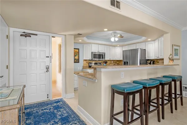 a kitchen with stainless steel appliances granite countertop a refrigerator and a stove top oven
