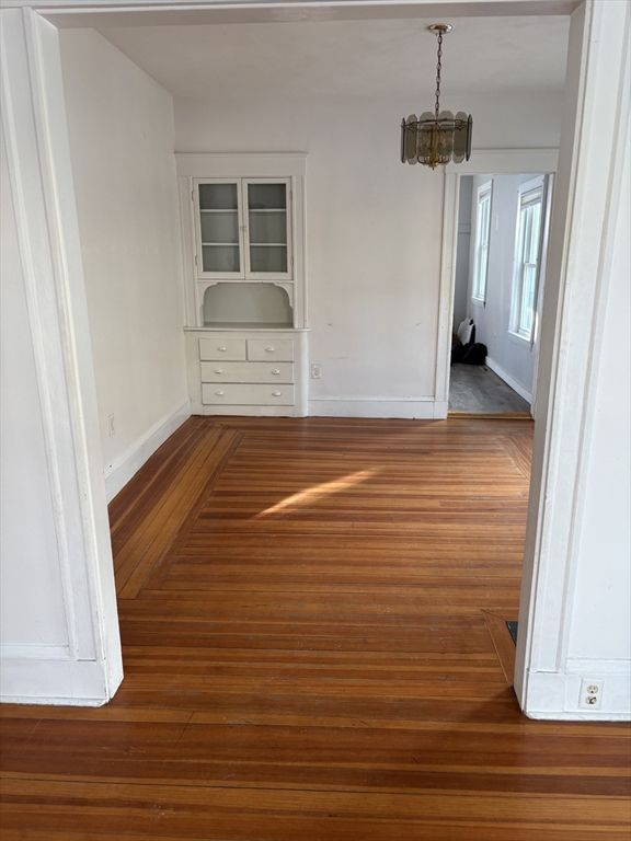 9 Maple Street Watertown, MA 02472 - Photo 2 of 11 a view of empty room with wooden floor and fan