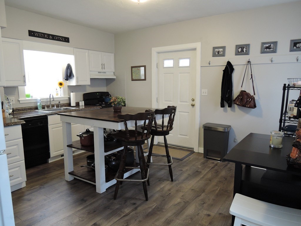 9 Maple Street Watertown, MA 02472 - Photo 4 of 11 a kitchen with a table chairs refrigerator and sink