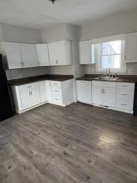 9 Maple Street Watertown, MA 02472 - Photo 5 of 11 a kitchen with granite countertop white cabinets and a granite counter tops