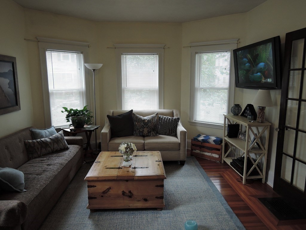 9 Maple Street Watertown, MA 02472 - Photo 6 of 11 a living room with furniture and a large window