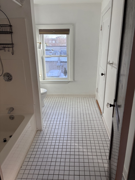 9 Maple Street Watertown, MA 02472 - Photo 10 of 11 a bathroom with a bathtub and a shower
