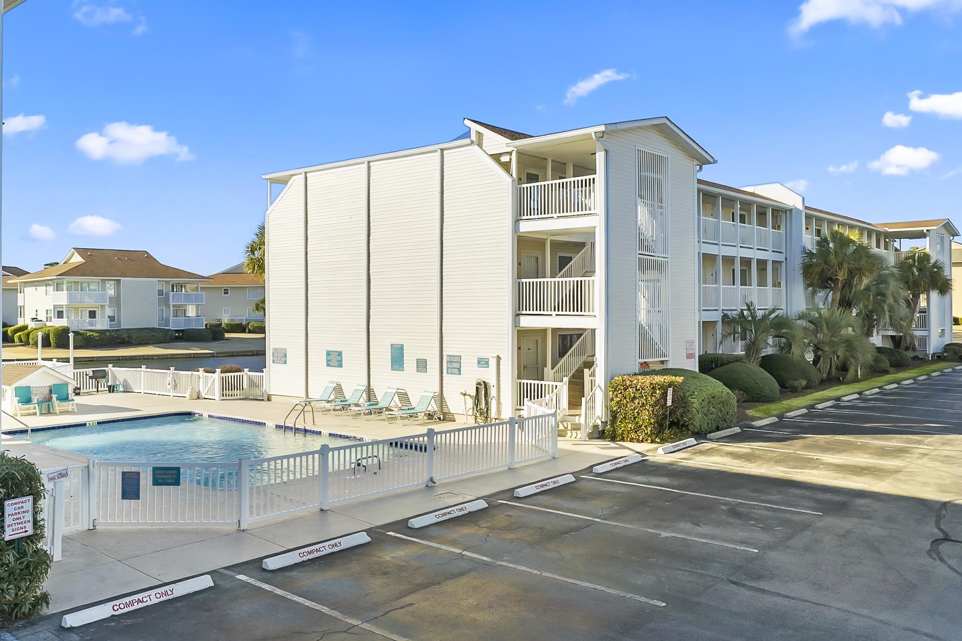 1919 Spring Street, Unit B12 North Myrtle Beach, SC 29582 - Photo 29 of 32 View of apartment building / complex with a community pool and uncovered parking