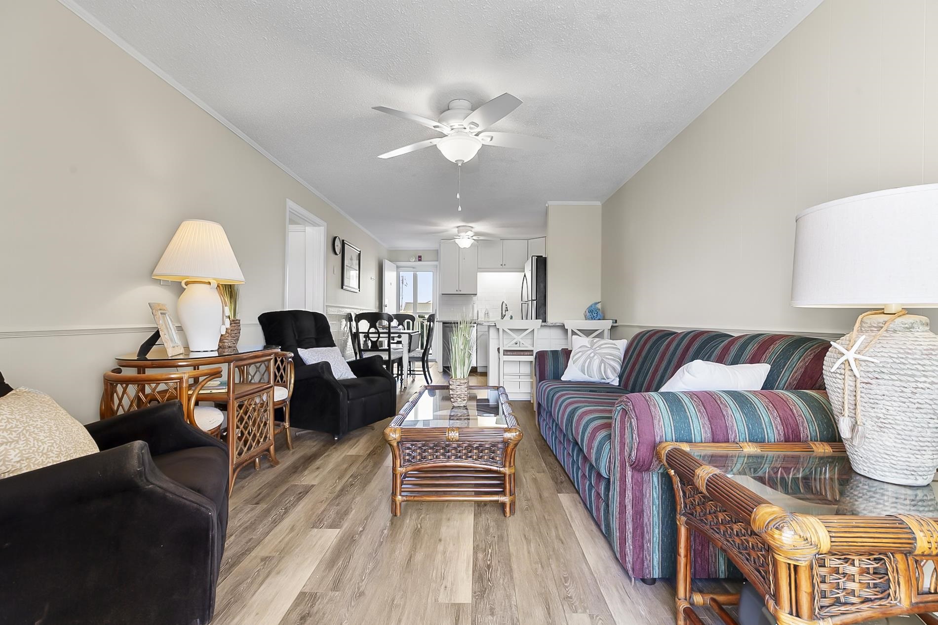 1919 Spring Street, Unit B12 North Myrtle Beach, SC 29582 - Photo 3 of 32 Living area featuring a textured ceiling, wood finished floors, and a ceiling fan
