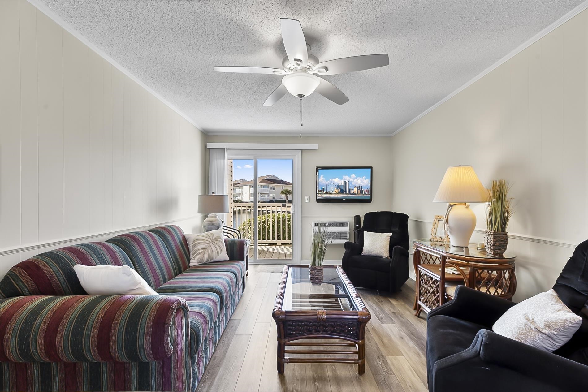 1919 Spring Street, Unit B12 North Myrtle Beach, SC 29582 - Photo 5 of 32 Living area with ornamental molding, hardwood / wood-style flooring, a ceiling fan, and a textured ceiling