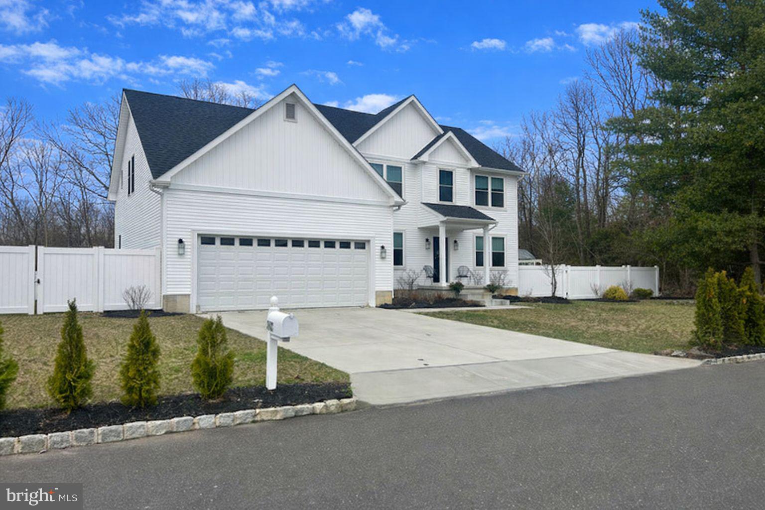 442 Waterfords Edge Court Atco, NJ 08004 - Photo 3 of 37 a view of a white house with a yard and table and chairs under an umbrella