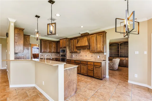 a kitchen with stainless steel appliances kitchen island granite countertop a sink and cabinets