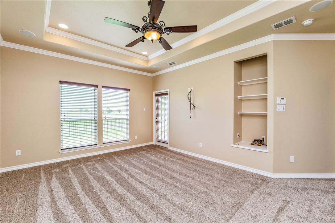307 Heathercrest Portland, TX 78374 - Photo 15 of 40 a view of an empty room with a window and a ceiling fan