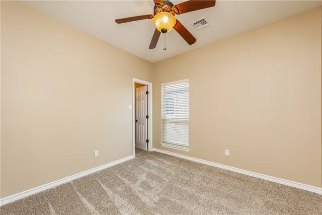 a bathroom with a granite countertop sink a toilet and a shower