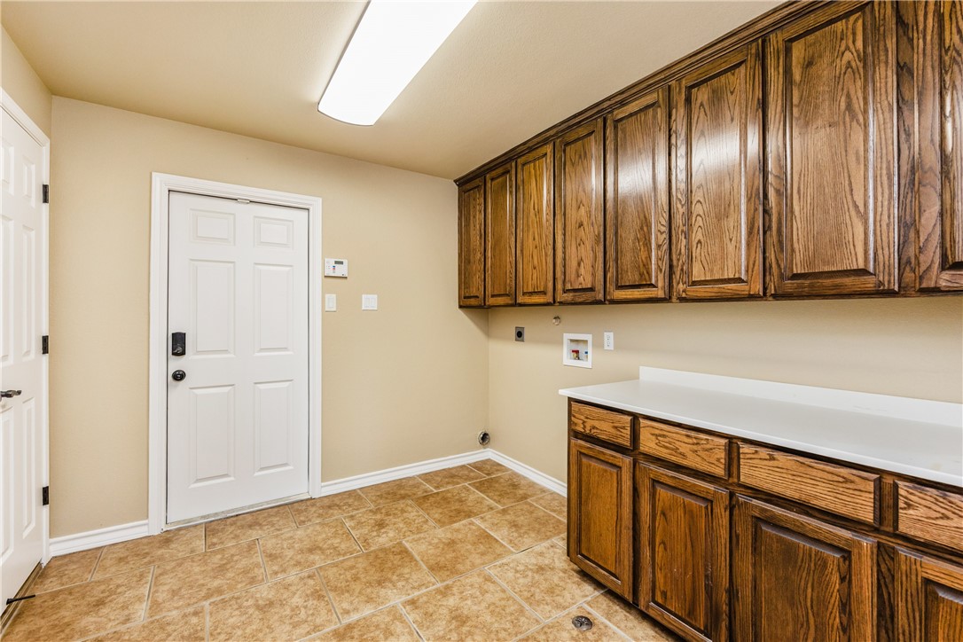 307 Heathercrest Portland, TX 78374 - Photo 36 of 40 a view of a refrigerator in kitchen and cabinets