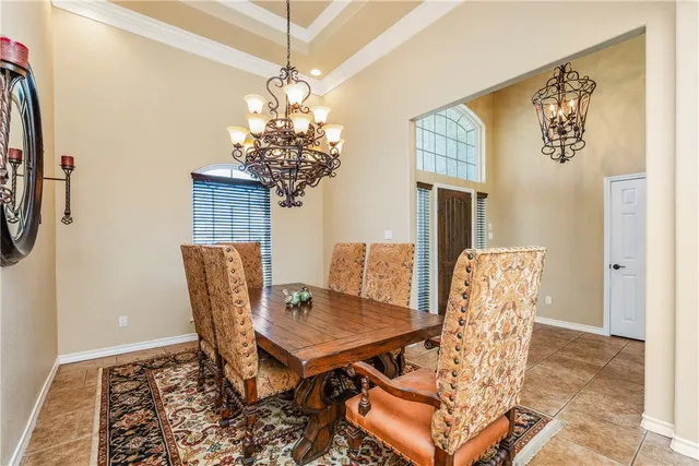 a view of a dining room with furniture and chandelier
