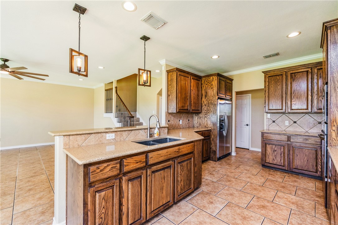 307 Heathercrest Portland, TX 78374 - Photo 10 of 40 a kitchen with a sink refrigerator and cabinets