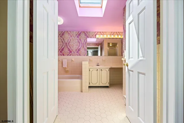 a view of a bathroom with a sink and a window