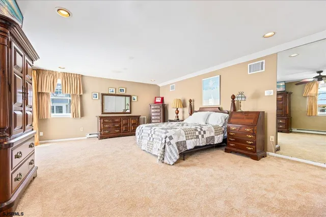 a bedroom with a large bed and a tv