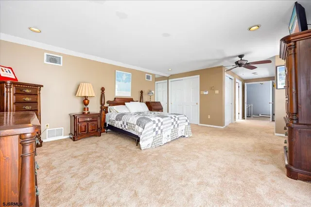 a spacious bedroom with a bed and a couch