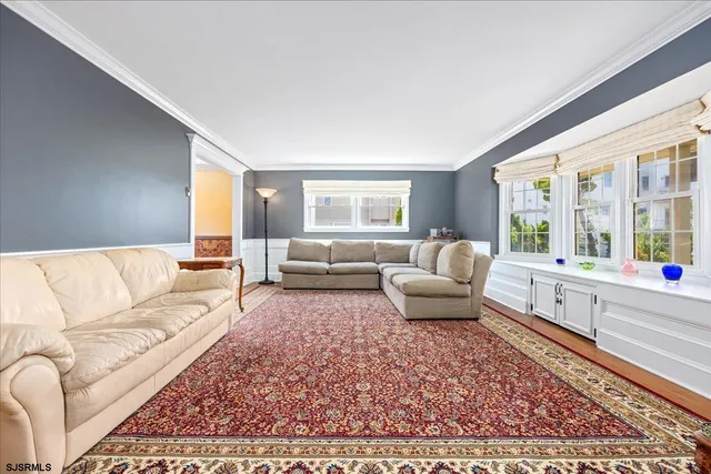 a living room with furniture and a large rug