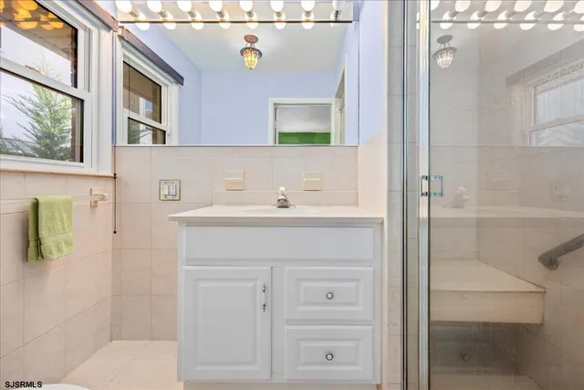 a bathroom with a sink vanity and a mirror