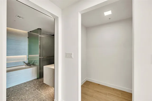 a view of an empty room with glass windows