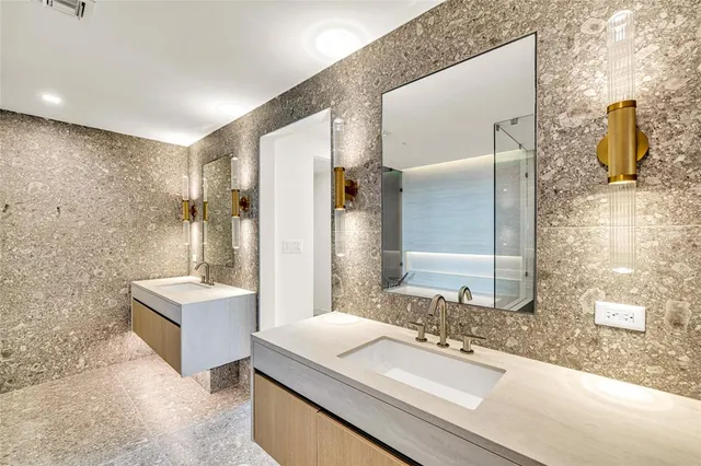 a bathroom with a toilet sink vanity and mirror