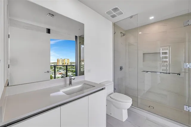 a row of palm trees in a backyard of a house