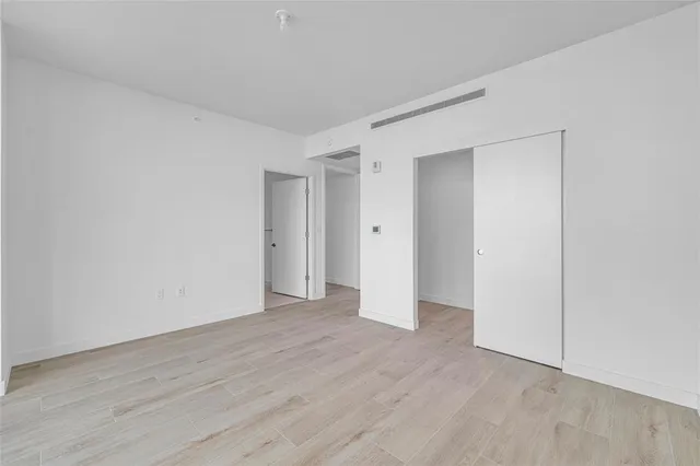 a bathroom with a toilet sink vanity and mirror