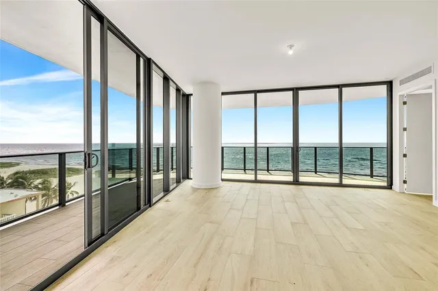 a large kitchen with stainless steel appliances a large window and counter space