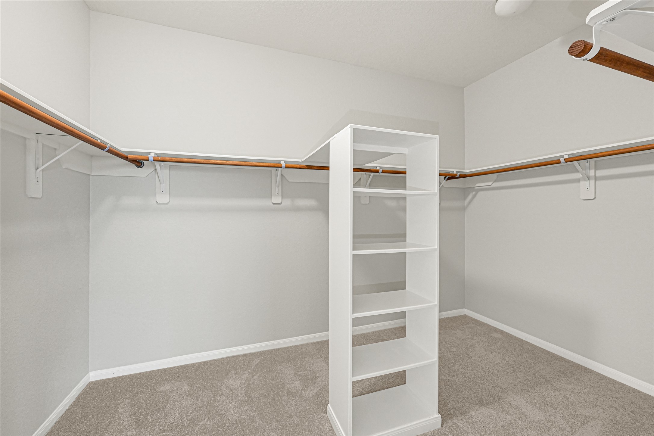 5331 Seabird Street Baytown, TX 77521 - Photo 26 of 38 a view of walk in closet with empty racks