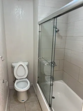 a bathroom with a toilet and a shower
