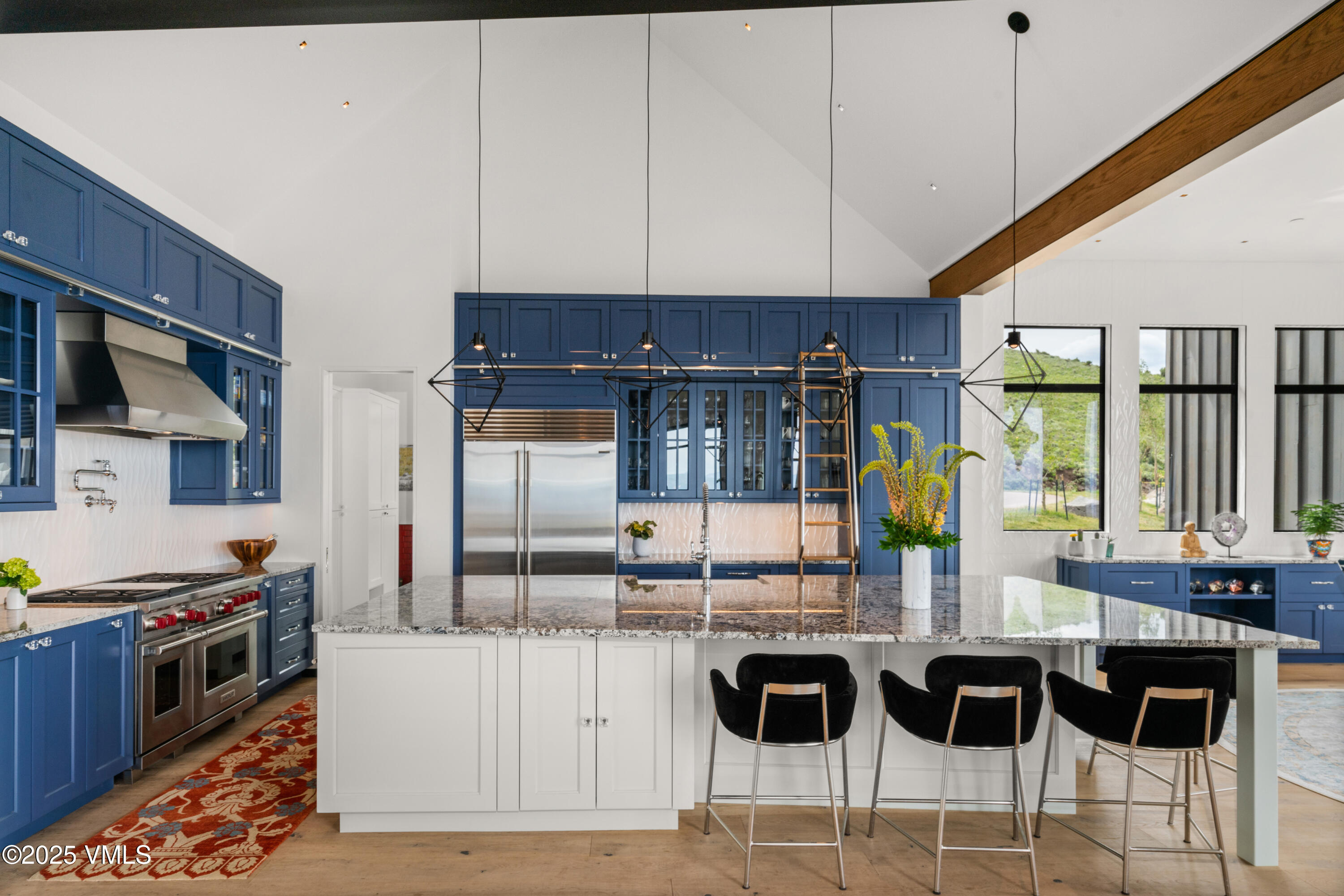 594 Winchester Trail Edwards, CO 81632 - Photo 6 of 46 a kitchen with granite countertop a stove a sink a dining table and chairs